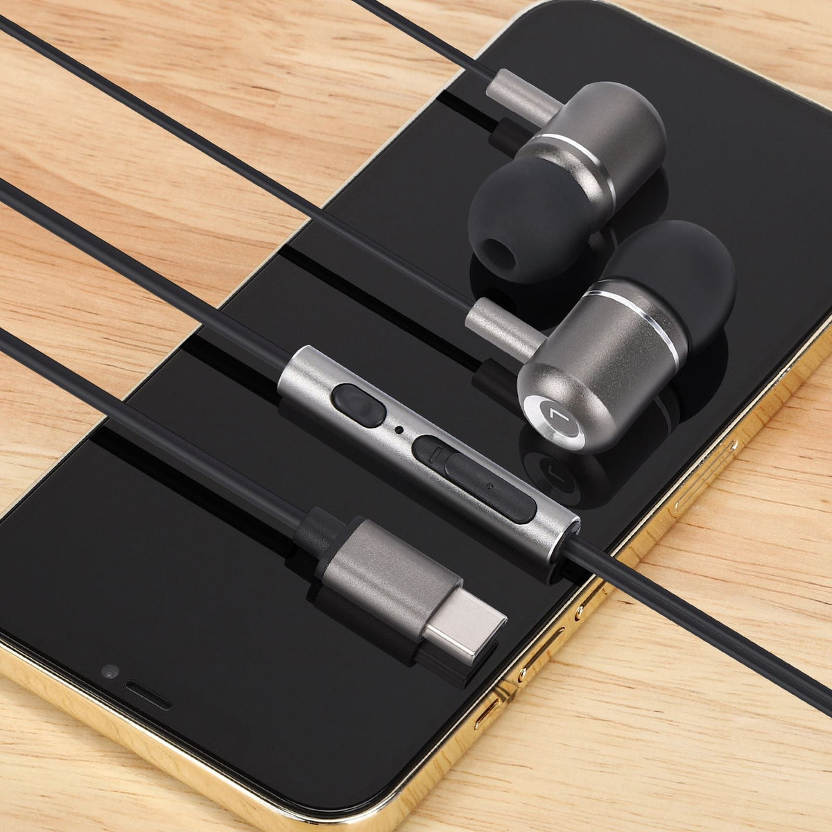 Tron wired earbuds on a desk
