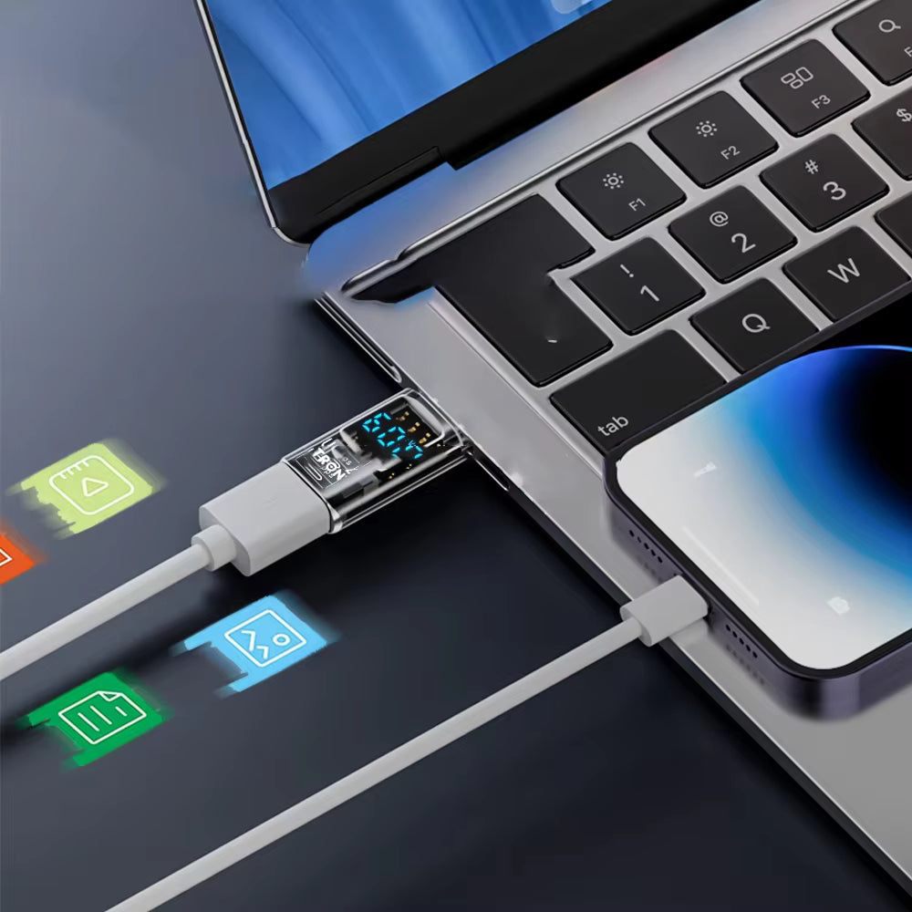 Tron USB-C adapter with power display plugged into a laptop